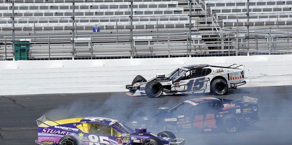 Whelen Modified Tour driver Bobby Santos (44) races between Todd Szegedy and Woody Pitkat to win Friday's All-Star Shootout at New Hampshire Motor Speedway.