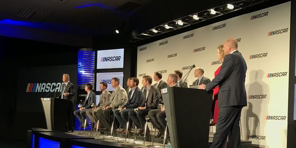A panel of former and current drivers, as well as track promoters and team representatives sit on the stage Monday night in Charlotte, N.C.