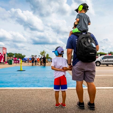 A father with his two young sons entering the New Hampshire Motor Speedway Fan Zone on Saturday, July 15, 2023. Kids 12 and under are free on Saturday of NASCAR weekends.