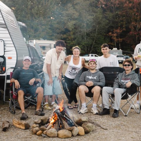 Campers relaxing by the fire at New Hampshire Motor Speedway on Sept. 20, 2025.