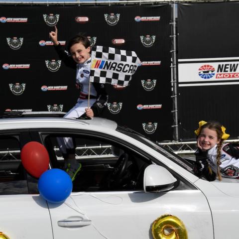 Jon and Abby McDonagh celebrate in victory lane at New Hampshire Motor Speedway after participating in Laps for Charity to benefit the New Hampshire Chapter of Speedway Children’s Charities on May 14, 2021.