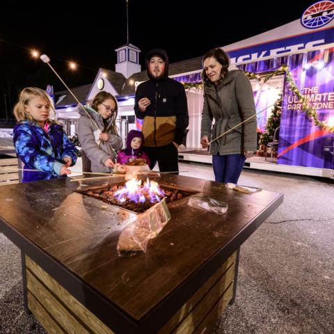 A local family toasts s’mores during Gift of Lights, which was held at New Hampshire Motor Speedway from Nov. 25, 2021 through Jan. 2, 2022. Proceeds from s’more kit purchases benefitted the New Hampshire Chapter of Speedway Children’s Charities.
