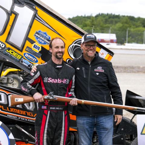 New Hampshire Motor Speedway Executive Vice President and General Manager David McGrath (right) presents Will Hull (left) with a musket after he won the Sprint Cars of New England feature during the inaugural Musket Dirt Shootout at The Flat Track Saturday.