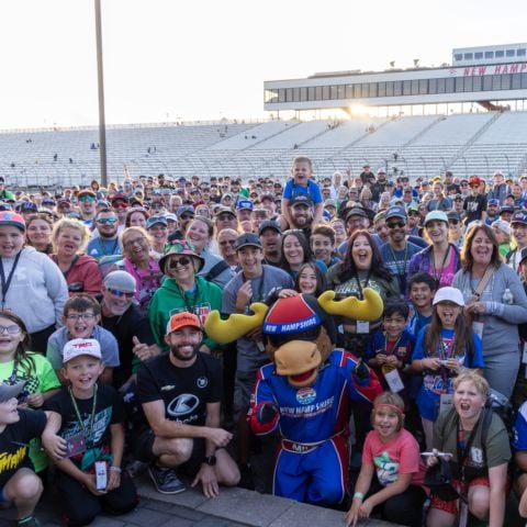Ross Chastain (front row, orange hat), NASCAR Cup Series driver of the No. 1 Trackhouse Racing Chevrolet, poses with the more than 400 race fans who participated in the annual Track Walk presented by LeMay Family Goodworks event at New Hampshire Motor Speedway on Sept. 20 to raise funds for the New Hampshire Chapter of Speedway Children’s Charities.