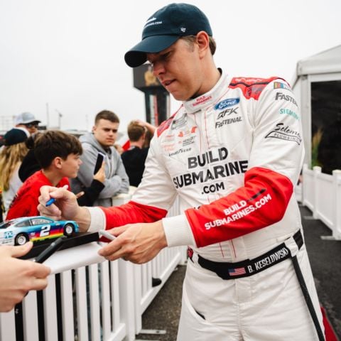 NASCAR Cup Series driver of the No. 6 RFK Racing Ford Brad Keselowski signs autographs at New Hampshire Motor Speedway on June 23, 2024.