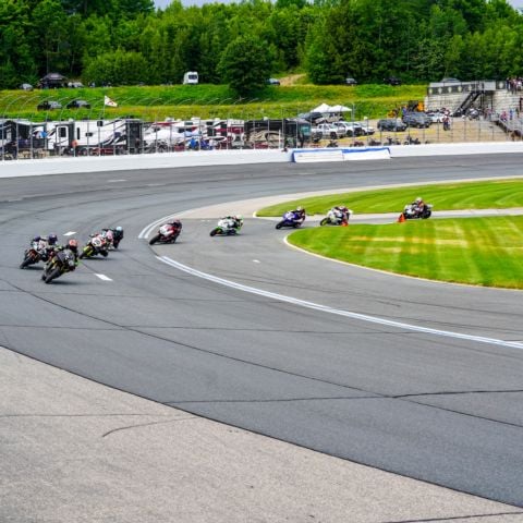 Riders exit the turn 12 chicane and race through turn 12a in pursuit of the start/finish line during the 101st annual Loudon Classic® at New Hampshire Motor Speedway on June 8, 2024.