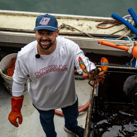 2023 Daytona 500 champion Ricky Stenhouse Jr., NASCAR Cup Series driver of the No. 47 Hyak Motorsports Chevrolet, proudly shows off the lobster he banded at Luke’s Lobster Portland Pier as part of his visit to Portland, Maine on Tuesday.