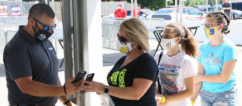 Nelly Roache and her daughters Jocelyn and Ashlee go through a mobile ticket scanning station during a special media “Journey of the Fan” event on Friday, July 31, 2020. Digital tickets are part of New Hampshire Motor Speedway’s new safety protocols put in place ahead of Sunday’s Foxwoods Resort Casino 301 NASCAR Cup Series race to limit person-to-person contact.