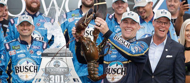 2014 NASCAR Cup Series champion Kevin Harvick earned his third of four New Hampshire Motor Speedway victories on July 22, 2018 and holds up Loudon the Lobster after taking the checkered flag in the Foxwoods Resort Casino 301.