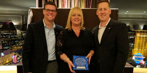 Lisa McGahan (center) with NHMS GM David McGrath (left) and VP of Corporate Sales Mike Ziegler.