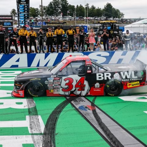 Layne Riggs, NASCAR CRAFTSMAN Truck Series driver of the No. 34 Front Row Motorsports Ford, celebrates with a burnout across the Granite Stripe start/finish line at New Hampshire Motor Speedway following his Team EJP 175 victory on Saturday.