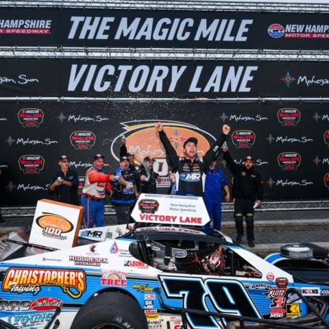 Jonathan McKennedy, NASCAR Whelen Modified Tour driver of the No. 79 Jonathan McKennedy Racing Modified, celebrates in victory lane at New Hampshire Motor Speedway following his Mohegan Sun 100 victory on Saturday.