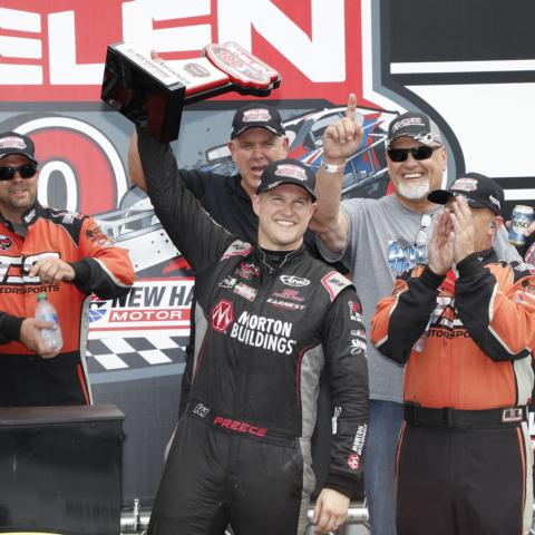 Ryan Preece (center) celebrates in victory lane at New Hampshire Motor Speedway Saturday after earning his first NASCAR Whelen Modified Tour points win at his home track at the Whelen 100.