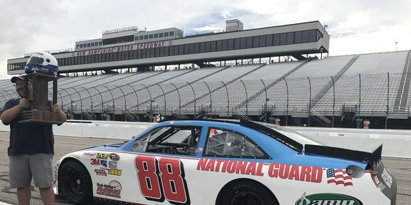 Nick Stoico of the Concord Monitor celebrates his win in the inaugural Media Racing Challenge at New Hampshire Motor Speedway on Friday.