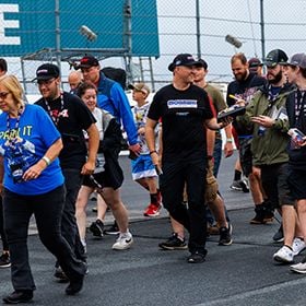NASCAR Cup Series driver and New England native Ryan Preece (center) walked with race fans around “The Magic Mile” on June 22, 2024 during last year’s Track Walk – one of several fundraising events held at New Hampshire Motor Speedway during the track’s annual NASCAR weekend to benefit the New Hampshire Chapter of Speedway Children’s Charities.