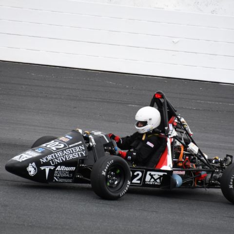 The No. 202 electric vehicle from Formula SAE Electric at Northeastern University in Boston, Mass. takes part in the on-track portion of the 2023 Formula Hybrid + Electric competition at New Hampshire Motor Speedway.